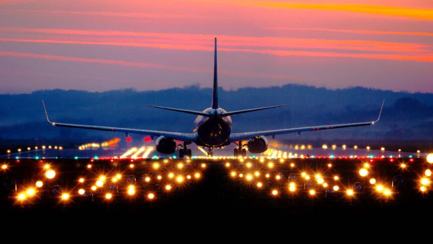 airliner on runway at sunset