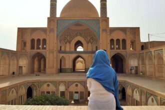 woman prays in Iran