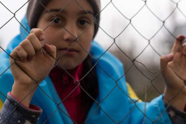 migrant behind fence